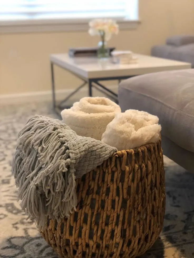 Extra Pillows and Blankets stored in a woven basket for guest Bedroom