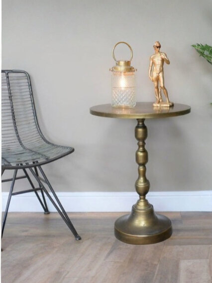 End table decorated with brass figurine