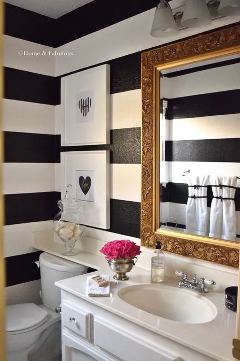 Black and White Framed Artwork Are Hanging Above the Toilet