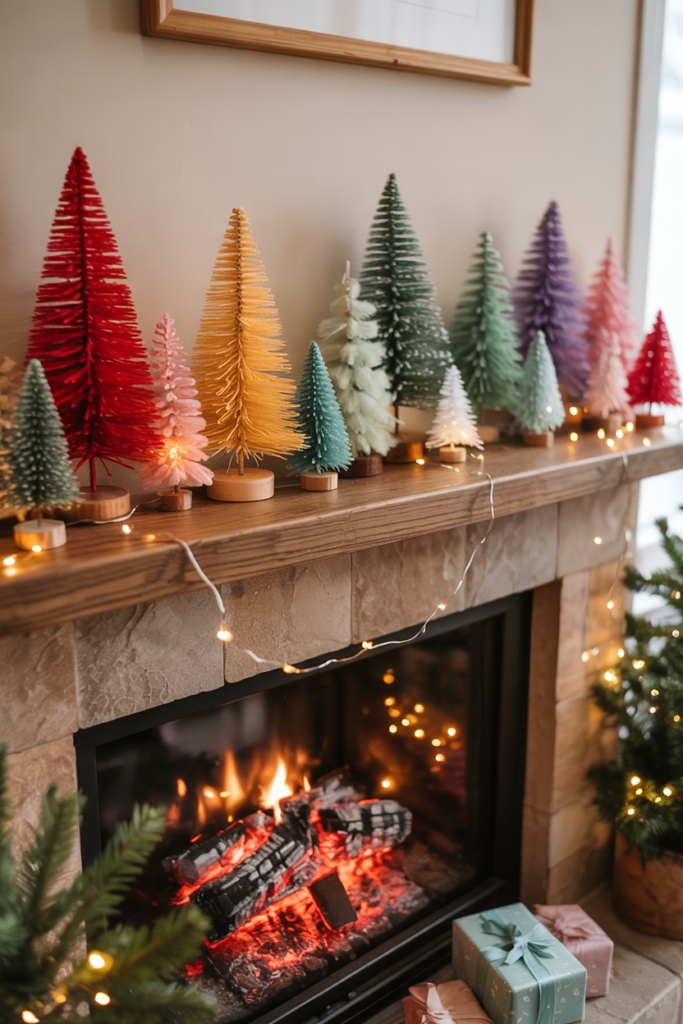A Christmas fireplace mantel decorated with a rainbow of miniature bottle-brush and felt trees, creating a playful, nostalgic, and colorful holiday display.